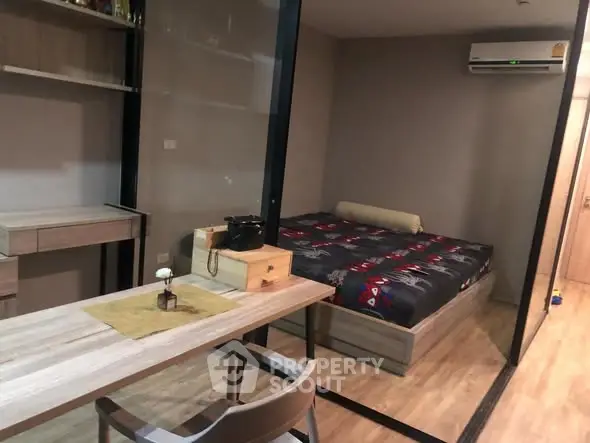 Modern bedroom with study area and air conditioning in sleek apartment.