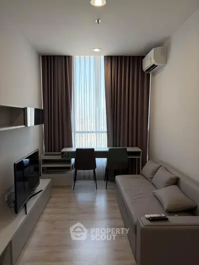 Modern living room with sleek furniture and natural light, perfect for urban living.