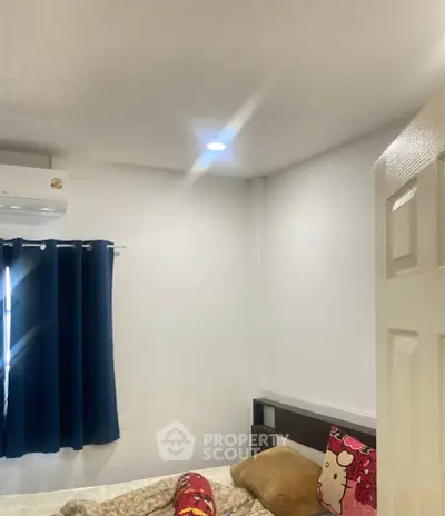 Cozy bedroom with plush bedding and air conditioning, perfect for relaxation.