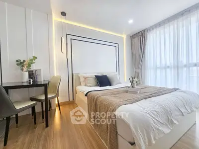 Modern bedroom with cozy decor and natural light, featuring a stylish bed and elegant furnishings.