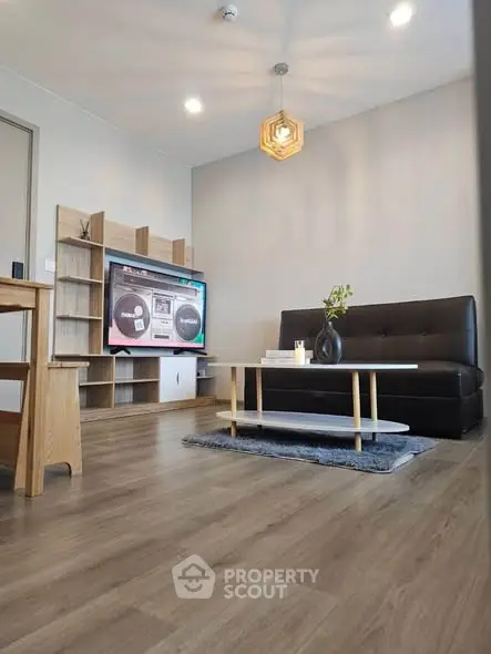 Modern living room with stylish furniture and wooden flooring, perfect for cozy gatherings.
