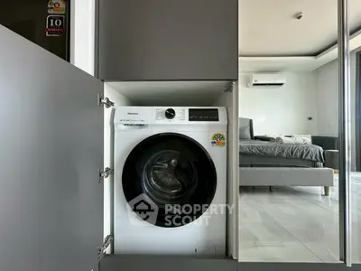 Modern apartment with built-in washing machine and stylish bedroom view.