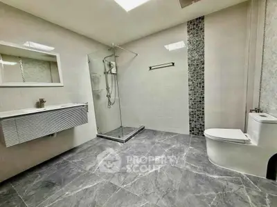 Spacious modern bathroom with sleek design and glass shower enclosure