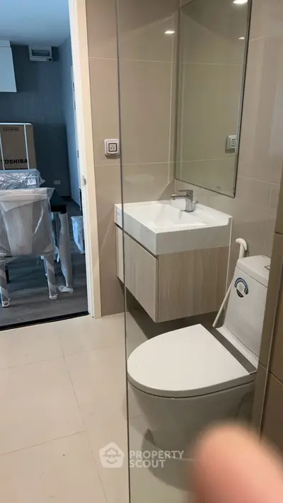 Modern bathroom with sleek fixtures and a glimpse of adjacent room