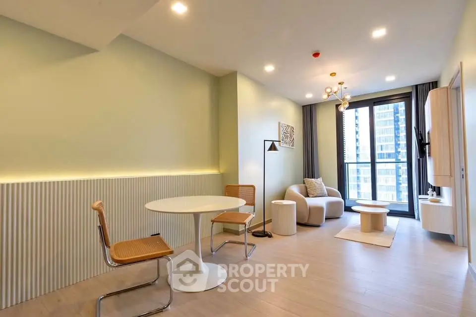 Modern living room with stylish furniture and large window offering city view