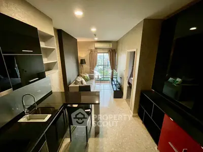 Modern open-layout kitchen and living room with balcony view in stylish apartment