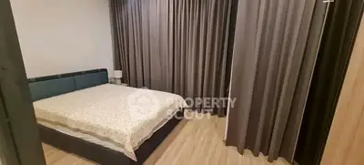 Spacious bedroom with elegant curtains and modern decor