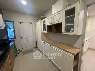 Spacious kitchen with modern cabinetry and sleek countertops, perfect for culinary enthusiasts.