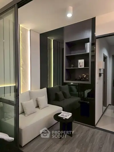 Modern living room with sleek design, featuring a cozy sofa, stylish shelving, and ambient lighting.