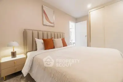 Elegant bedroom with modern decor and cozy ambiance, featuring a plush bed and stylish nightstand.