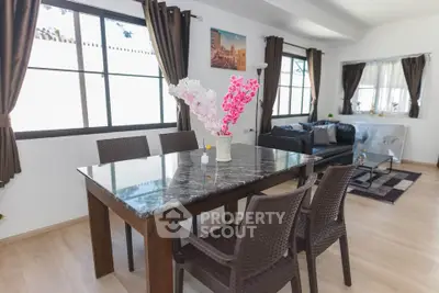 Spacious living room with elegant dining area and natural light