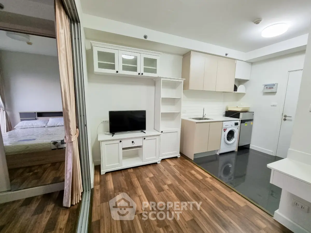 Modern studio apartment with open kitchen and cozy bedroom