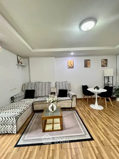 Stylish living room with modern decor and cozy seating area, perfect for relaxation and entertaining.