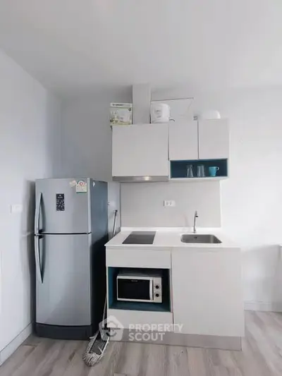 Modern compact kitchen with sleek appliances and minimalist design