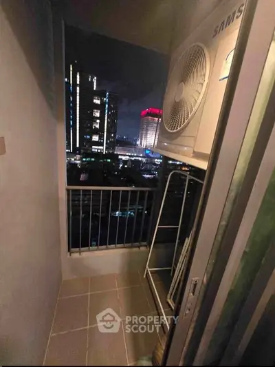 Cozy balcony with city view, perfect for relaxing evenings in urban setting.