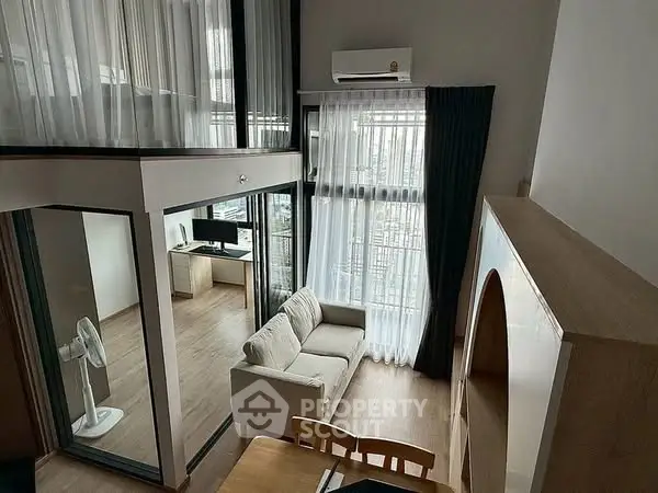 Modern duplex apartment with large windows and stylish interior design