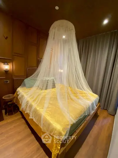 Luxurious bedroom with elegant canopy bed and warm wooden accents