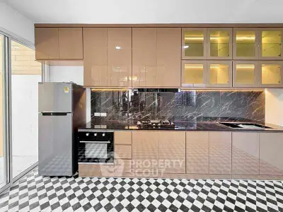 Modern kitchen with sleek cabinetry and gas stove in stylish apartment.