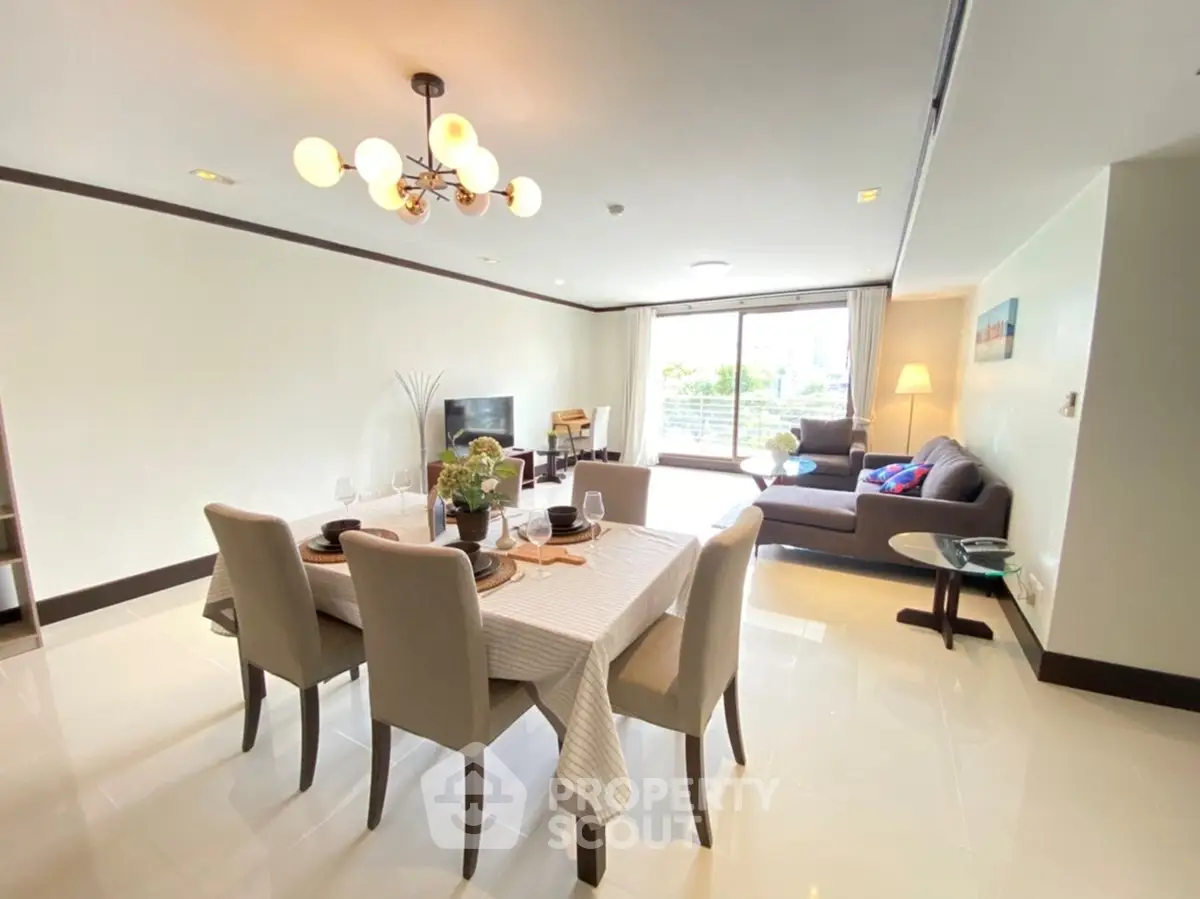 Spacious modern living and dining area with elegant decor and natural light.