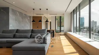 Spacious modern living room with large windows and city view