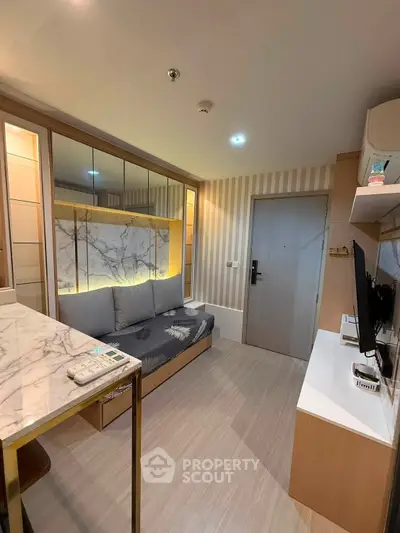Modern living room with stylish decor and marble accents in a cozy apartment.