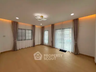 Spacious empty living room with elegant lighting and large windows