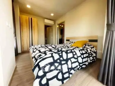 Cozy bedroom with modern decor and stylish bedding in a contemporary apartment.