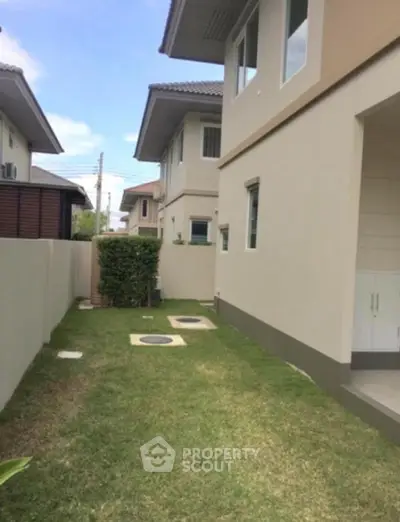Modern two-story house with well-maintained lawn and contemporary exterior design