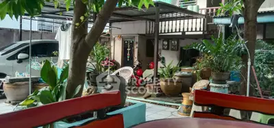 Charming garden area with lush greenery and cozy seating, perfect for relaxation.