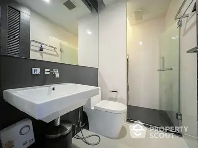 Modern bathroom with sleek fixtures and glass shower enclosure