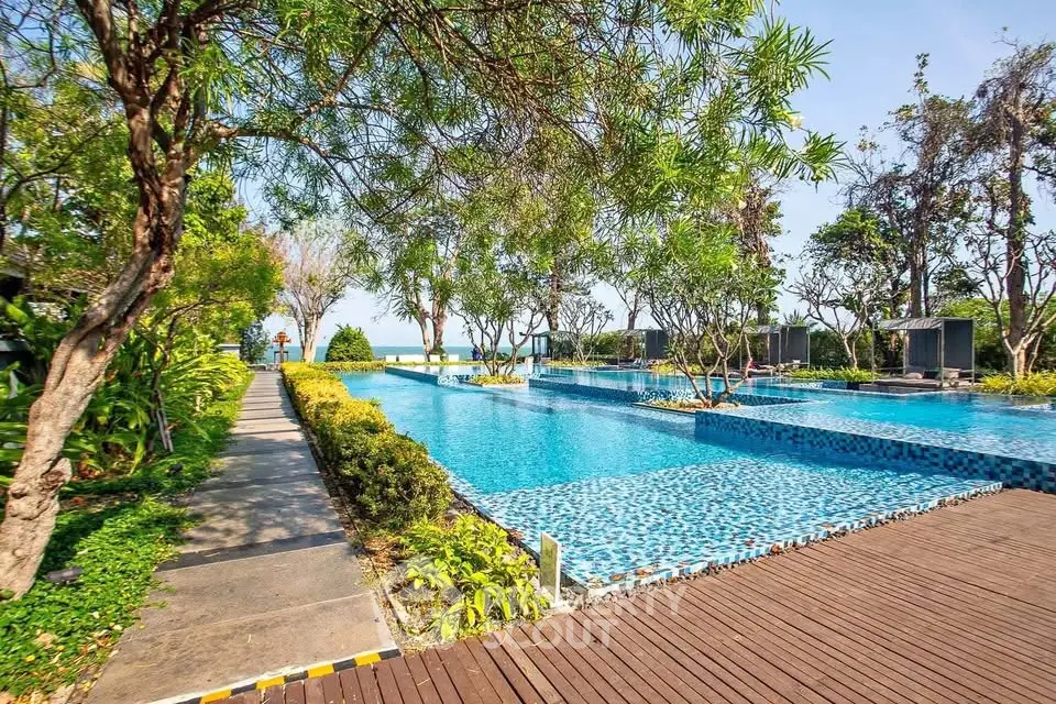 Luxurious outdoor pool area with lush greenery and serene ambiance, perfect for relaxation and leisure.