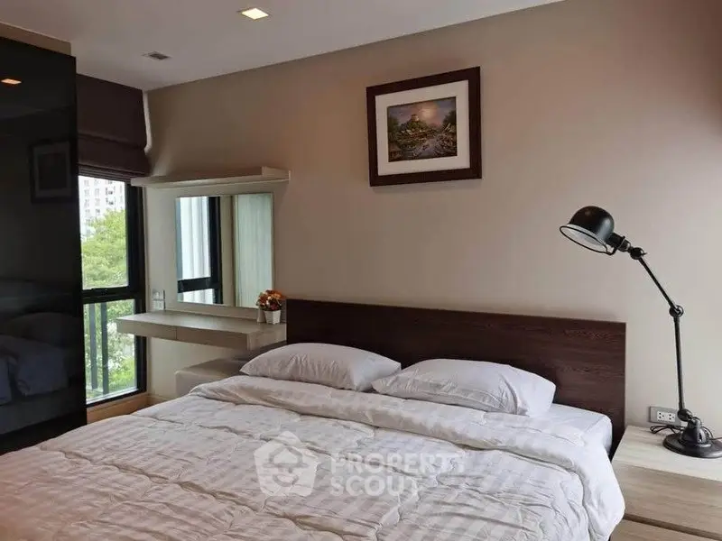 Cozy bedroom with large window and modern decor in urban apartment