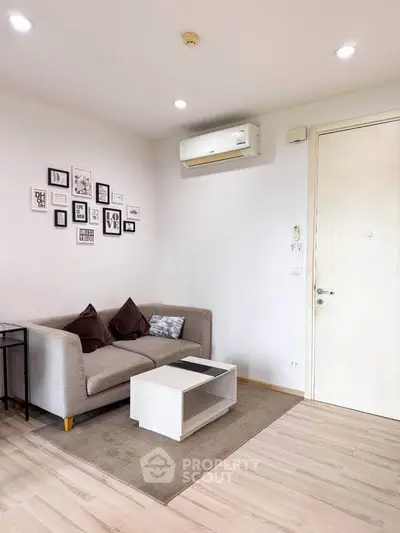 Cozy living room with modern decor and air conditioning, perfect for relaxation.