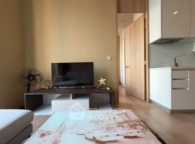 Modern living room with sleek TV stand and compact kitchen area
