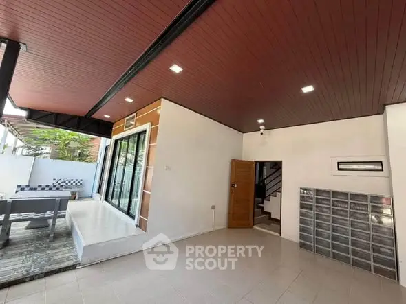 Modern home entrance with sleek design and spacious patio area