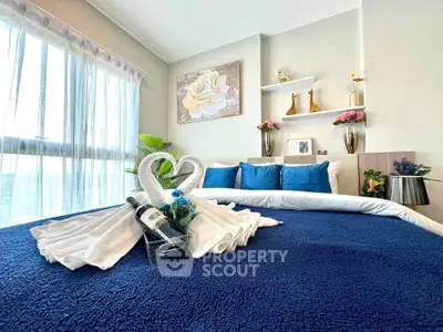 Luxurious bedroom with elegant decor and natural light, perfect for relaxation.