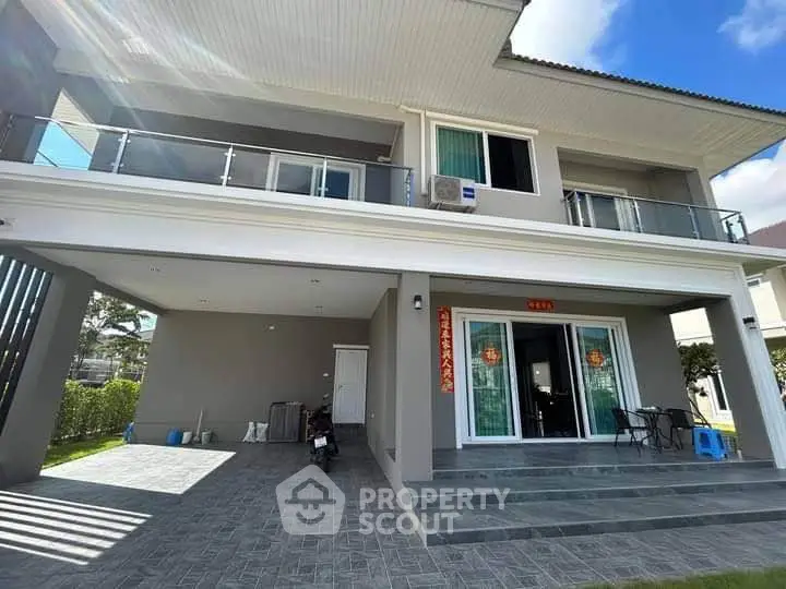 Stunning modern two-story house with spacious balcony and elegant entrance.