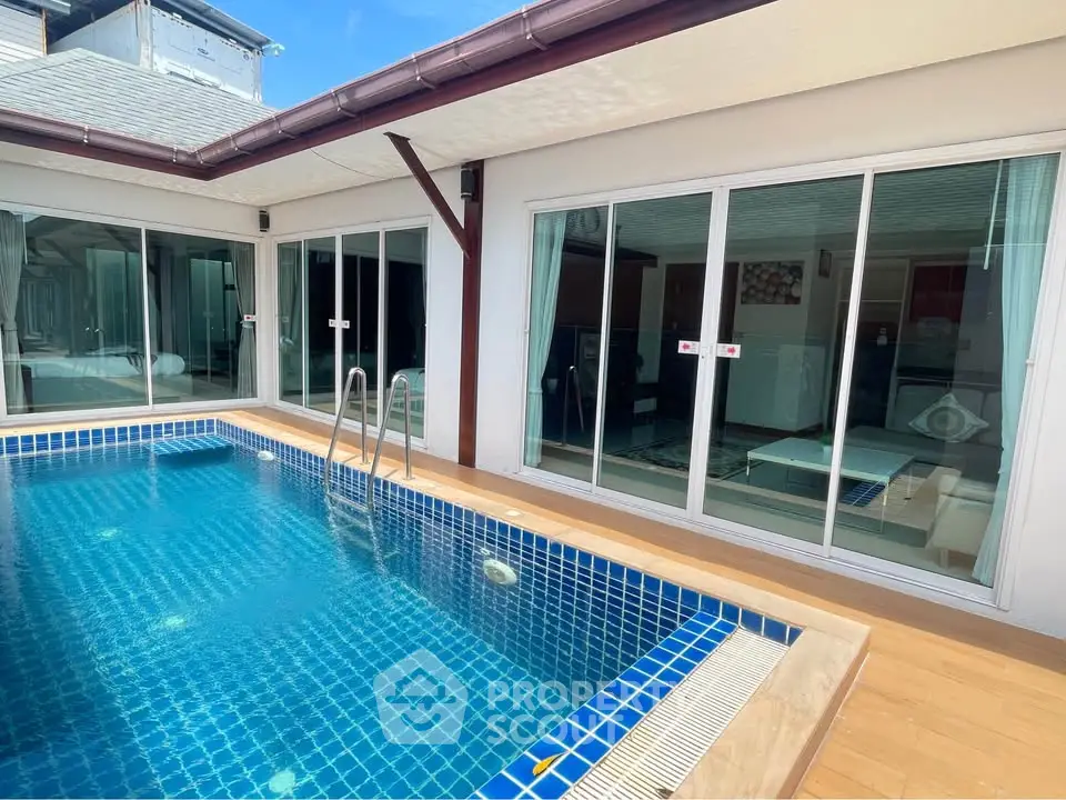 Luxurious private pool area with modern sliding glass doors and elegant wooden deck.