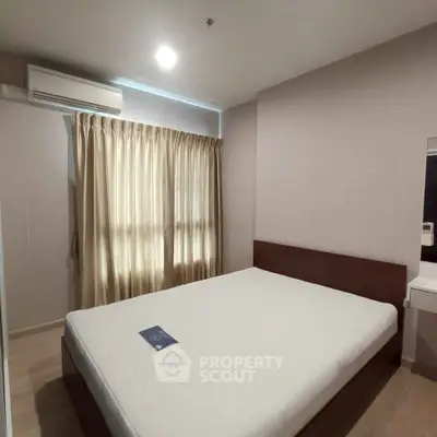 Cozy bedroom with natural light and modern furnishings in a stylish apartment.