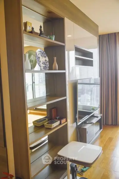 Modern living room with stylish shelving and city view, perfect for urban living.