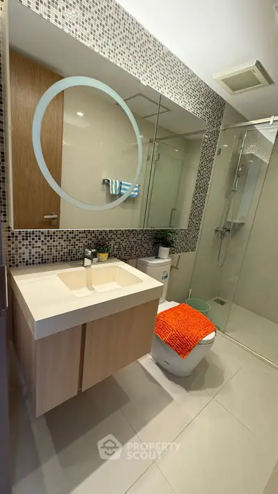 Modern bathroom with stylish vanity and glass shower enclosure