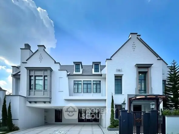 Stunning modern white mansion with elegant architecture and spacious driveway.