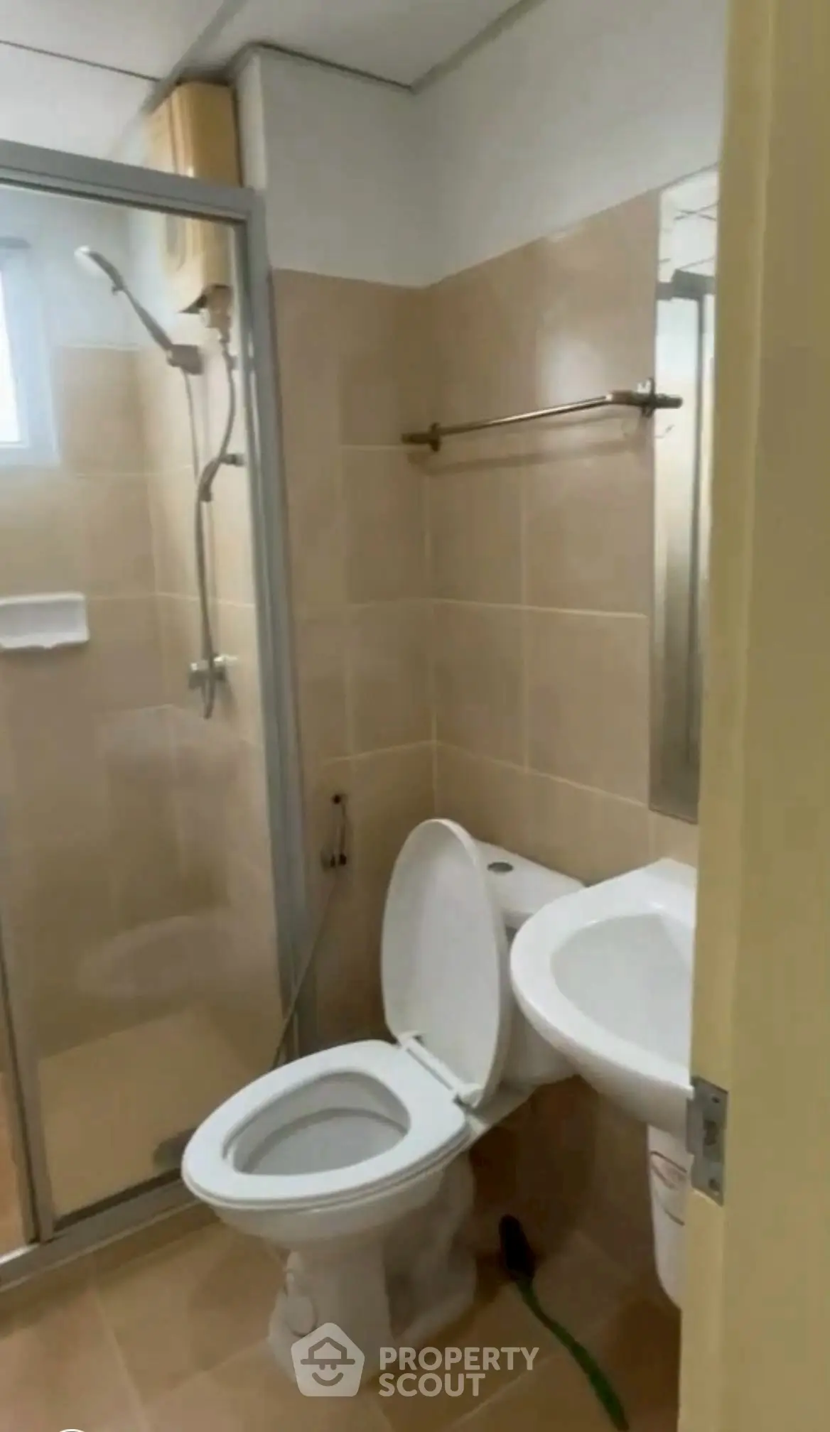 Compact bathroom with shower and modern fixtures in cozy apartment.