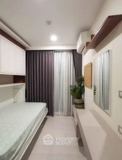 Modern bedroom with sleek design, featuring built-in storage and elegant curtains.