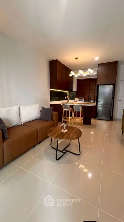 Modern open-plan living room with stylish kitchen and cozy seating area