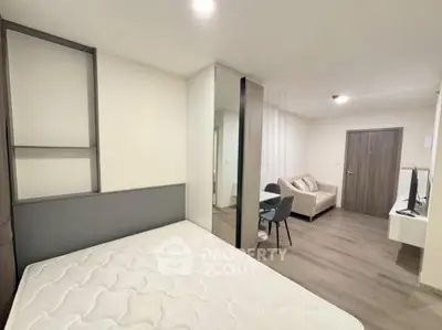 Modern studio apartment with open layout, featuring a cozy living area and sleek furnishings.