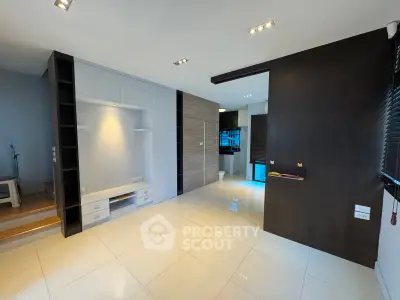 Spacious modern living room with sleek design and glossy tiled floors