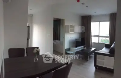 Modern open-plan living room with dining area and large window view