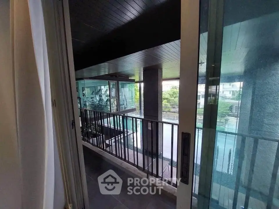 Modern apartment with pool view and glass balcony, perfect for urban living.