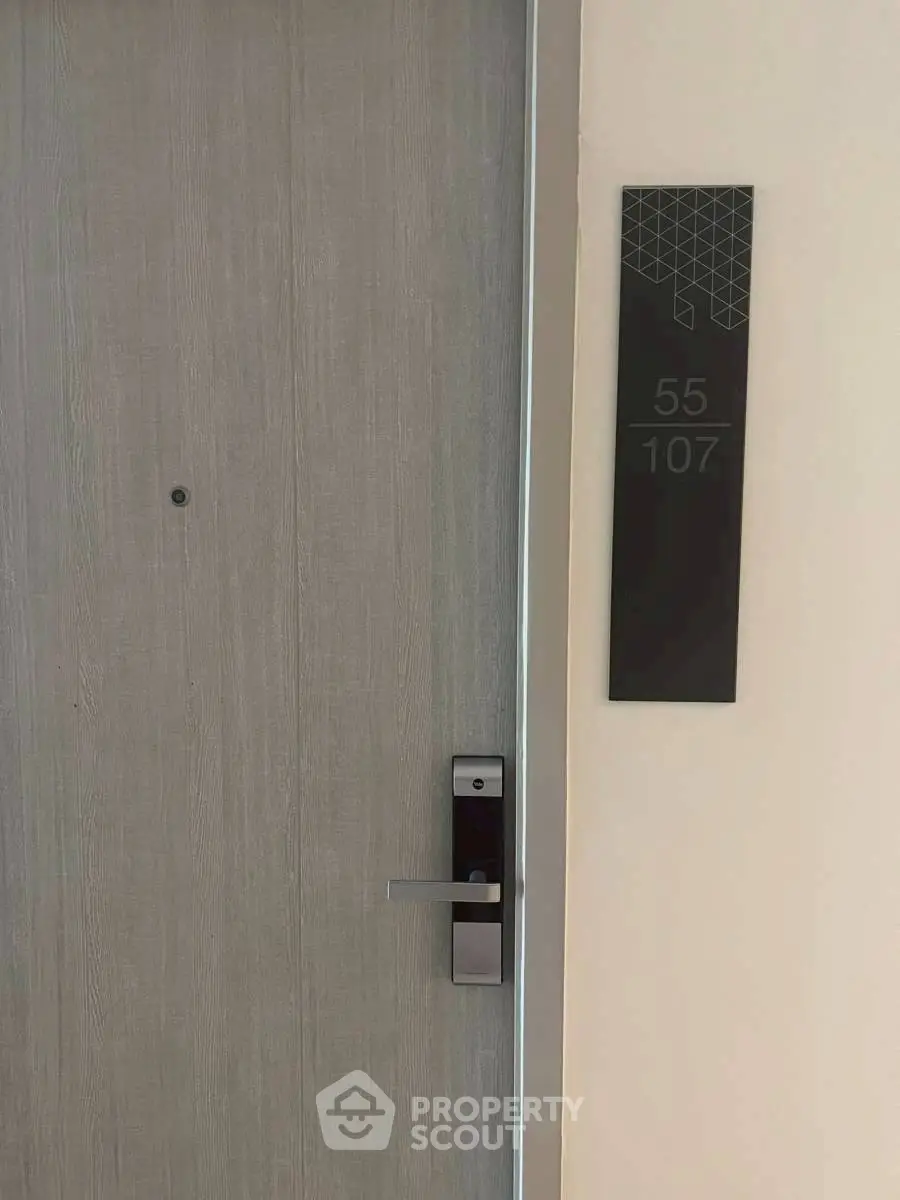 Modern apartment entrance with sleek door and digital lock system